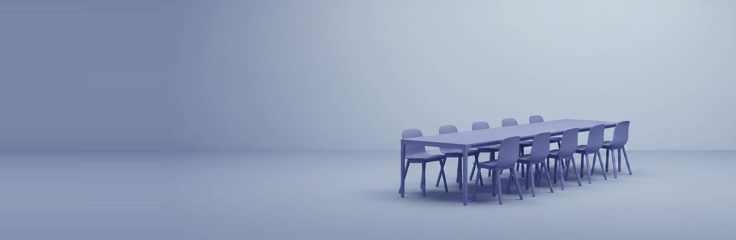 Ein Sitzungstisch mit Stühlen — Sinnbild für Zusammenarbeit